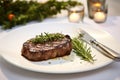 Steak, fork and knife, rosemary and garlic Royalty Free Stock Photo