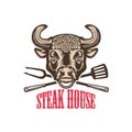 Steak house. Bull head with kitchen tools. Design element for logo, label, emblem, sign. Royalty Free Stock Photo