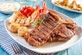 Steak and lobster meal with side dishes Royalty Free Stock Photo