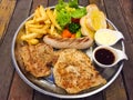 Steak mixed with gravy sauce, there are grilled Chicken , Pork chop with black pepper , grilled Sausage , French fries and Salad Royalty Free Stock Photo