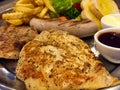 Steak mixed with gravy sauce, there are grilled Chicken , Pork chop with black pepper , grilled Sausage , French fries and Salad Royalty Free Stock Photo