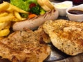 Steak mixed with gravy sauce, there are grilled Chicken , Pork chop with black pepper , grilled Sausage , French fries and Salad Royalty Free Stock Photo