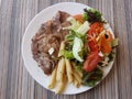 Steak with pasta and a salad with tomato and carrot Royalty Free Stock Photo