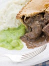 Steak Pie and Mash with Mushy Peas Royalty Free Stock Photo