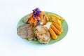 Steak pork chop topped with black pepper sauce and sausage with french fries and vegetable salad on dish with white background. Royalty Free Stock Photo