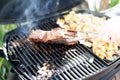Steak and potato cooking on a outdoor grill Royalty Free Stock Photo