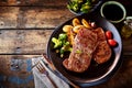 Steak, potato and vegetable dinner on table Royalty Free Stock Photo