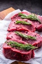 Steak. Raw beef steak. Fresh raw Sirloin beef steak sliced o Herb - Rosemary decoration Royalty Free Stock Photo