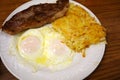 Steak ribs with two eggs over easy and Hash-brown potatoes Royalty Free Stock Photo