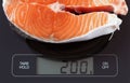 Steak of salmon fish on kitchen scale Royalty Free Stock Photo