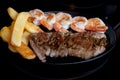 Steak shrimps french fries skillet Royalty Free Stock Photo
