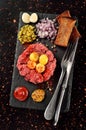 Steak tartare on black stone plate Royalty Free Stock Photo