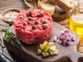 Steak tartare served with capers, pickled cucumbers and chopped onion