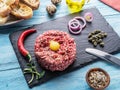 Steak tartare served with raw quail egg yolk, capers and bread. Meat dish Royalty Free Stock Photo