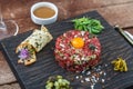 Steak tartare served with raw quail egg yolk and other tartare ingredient. Meat dish. Royalty Free Stock Photo