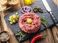 Steak tartare served with raw quail egg yolk and other tartare ingredient. Meat dish Royalty Free Stock Photo