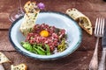 Steak tartare served with raw quail egg yolk and other tartare ingredient. Meat dish. Royalty Free Stock Photo