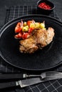 Steak thigh Turkey fillet with vegetables. Black background. Top view