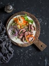 Steak tortilla with pickled carrots and cabbage on a wooden cutting board on dark background Royalty Free Stock Photo