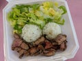 Steak, White Rice, toss salad in a styrofoam plate Royalty Free Stock Photo