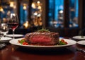 Steak and wine glasses are beautifully arranged on a table in a restaurant