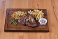 Steak on a wooden plate Royalty Free Stock Photo