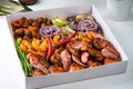 Steakhouse menu. Closeup of smoked meat, poultry assortment, baked Bonduelle corn.