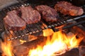 Steaks cooking over a campfire