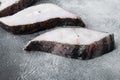 Steaks of fish and fillet of sea fish frozen, on gray stone table background Royalty Free Stock Photo