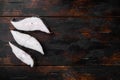 Steaks of fish and fillet of sea fish frozen, on old dark  wooden table background, top view flat lay, with copy space for text Royalty Free Stock Photo