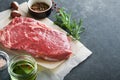 Steaks. Fresh New York Steaks raw with spices rosemary and pepper on black marble board on gray background. Top view. Mock up Royalty Free Stock Photo