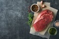 Steaks. Fresh New York Steaks raw with spices rosemary and pepper on black marble board on gray background. Top view. Mock up Royalty Free Stock Photo