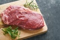 Steaks. Fresh New York Steaks raw with spices rosemary and pepper on black marble board on gray background. Top view. Mock up Royalty Free Stock Photo