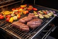 steaks grilling on a tailgate-style grill