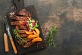 Steaks. Sliced grilled meat steak New York, Ribeye or Chuck roll with with garnished with salad and french fries on black marble Royalty Free Stock Photo