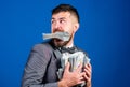 Steal money. Thief with piles dollars money. Earnings surprise concept. Man bearded businessman hold pile money blue