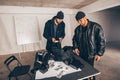 Stealers counting money in garage after a heist Royalty Free Stock Photo