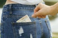 Stealing money from the back pocket of jeans Royalty Free Stock Photo