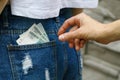 Stealing money from the back of your jeans pocket Royalty Free Stock Photo