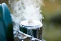 Steam billowing from a boiling pot of liquid