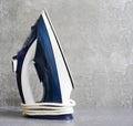 Steam blue iron on ironing board. Clothes ironing board household concept Royalty Free Stock Photo