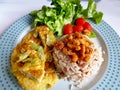 Steam brown rice top up fried dried shrimp with bitter gourd omelette and green lettuce Royalty Free Stock Photo