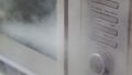 Steam cleaning a microwave oven door handle and exterior. To sterilise appliance.