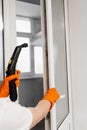 Steam cleaning of window frame at home. Professional cleaner is disinfecting window frame. Professional cleaning service