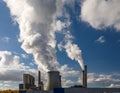 Steam clouds from cooling towers and smoke from chimneys of a brown coal power plant Royalty Free Stock Photo