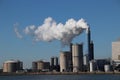 Steam coming out of the chimney at power plant in Rotterdam Maasvlakte in Netherlands Royalty Free Stock Photo