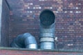 Steam coming out the top of two large metal air ventaltion ducts