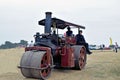 Two people on a steam engine