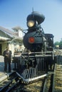 A steam engine conductor as he stands near the cowcatcher on the front, Eureka Springs, Arkansas