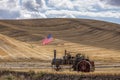 Steam engine and flag in field. Royalty Free Stock Photo